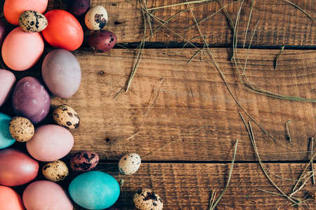 Colorful eggs. Top view of colored Easter eggs lying on wooden rustic tableの写真素材