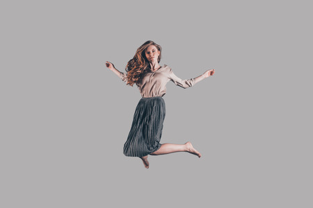 Moving free. Studio shot of attractive young woman hovering in airの写真素材