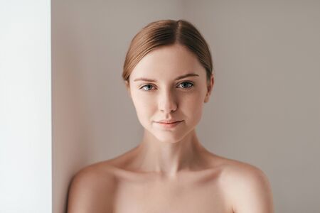 Confident and beautiful. Young woman with freckles on face looking at cameraの写真素材