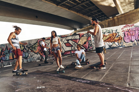 Their second home. Full length of young modern people getting ready to skate while hanging out...