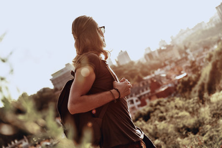 Amazed by the beauty. Young man in casual clothing looking at view while standing on the hill...