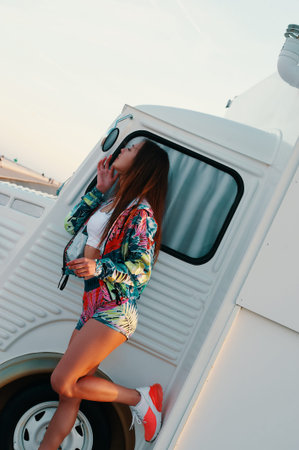 Young and carefree. Attractive young woman looking in the mirror and adjusting her lips while...