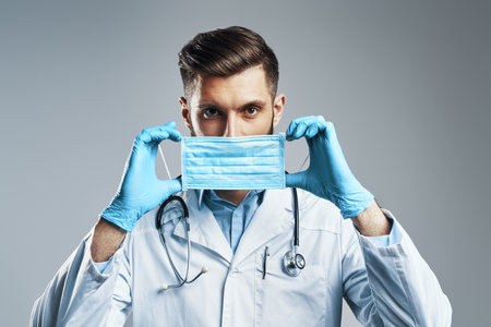 Confident young man in white lab coatの写真素材