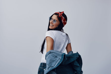 Fashionable young woman in bandana looking away and smiling