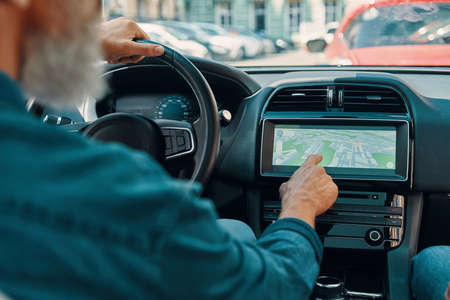 Close up rear view of active senior man using global positioning systemの写真素材