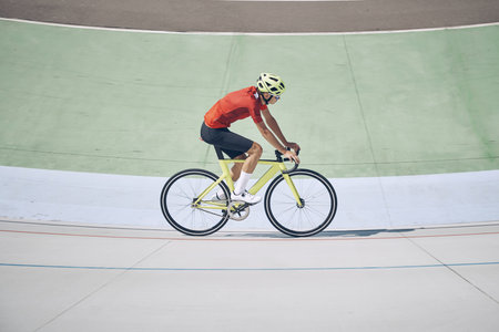 Top view of man in sports clothing cycling on track outdoorsの写真素材