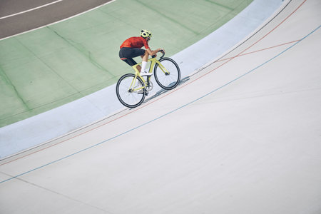 Top view of man in sports clothing cycling on track outdoorsの写真素材