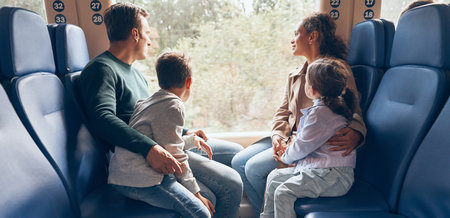 Family with two little kids enjoying train journey together