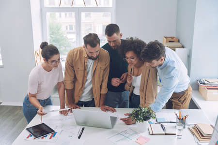 Top view of confident young people in smart casual wear discussing businessの写真素材