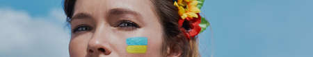 Close-up of beautiful young Ukrainian woman in floral crown looking at cameraの写真素材