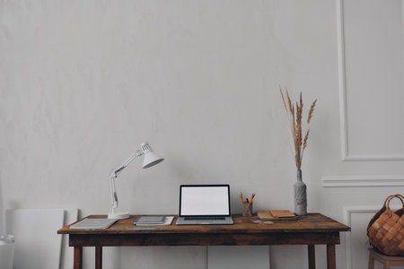 No people shot of creative workplace with laptop laying on the wooden deskの写真素材