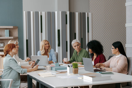 Group of confident mature women having business meeting in the officeの写真素材