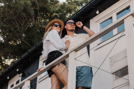 Beautiful loving couple bonding while spending time on the house terrace together