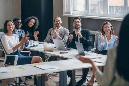 Group of happy people applauding to the speaker during business conference in convention centerの写真素材