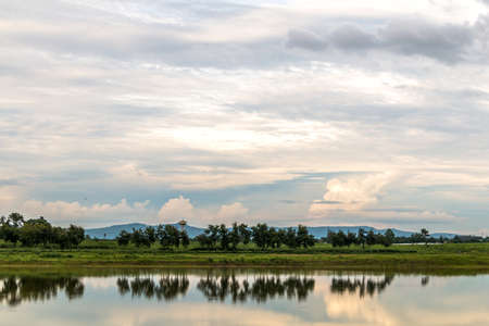 Landscape in cloudy day with fluffy cloudの写真素材