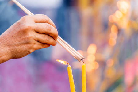 People are lighting incense stick to pray for goodnessの写真素材