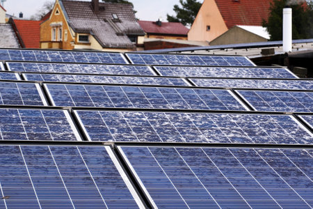 alternative electricity source. Photovoltaic solar panels covered with snow on rooftop house. Renewable energy production. Resources ecological power plant.の写真素材