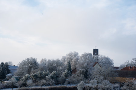 View of the germany village with chapel and church from the balcony in winter. Frost morning view. copy spaceの写真素材