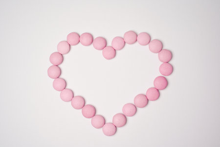 Sweets candies as heart on white background. Valentines day concept. flat lay. copyspace.の写真素材