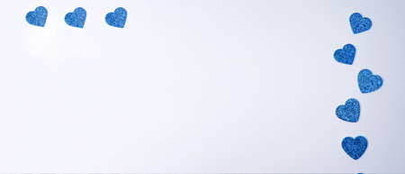 Glittering blue hearts on white background. Banner. Valentines day concept. copyspace. flat lay.の写真素材