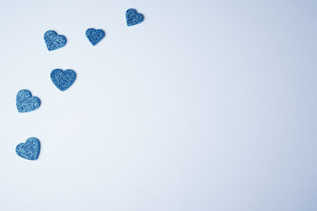 Glittering blue hearts on a white background. Valentines day minimal concept. father's day. copyspace. flat lay.の写真素材