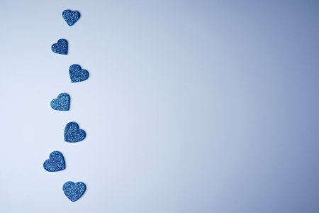 Glittering blue hearts on a white background. Valentines day minimal concept. father's day. copyspace. flat lay.の写真素材