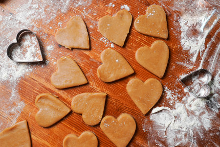 Heart cookies out dough and molds on table with flour. Valentine's Day celebration. home baking.の写真素材