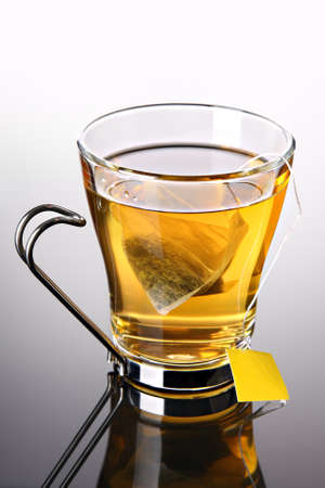 Cup of tea with pyramid teabag (concept)          の写真素材