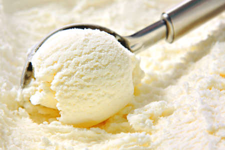 Vanilla ice cream scoop scooped out of container with untensilの写真素材