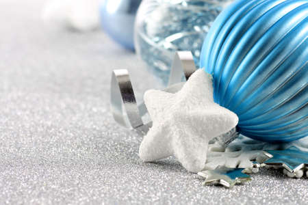 Holiday background with white snowflake and blue Christmas ornamentsの写真素材