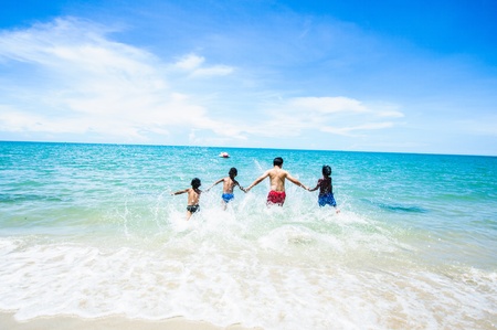 Young children leading to the sea の写真素材