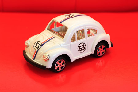 White model car isolated on red background の写真素材