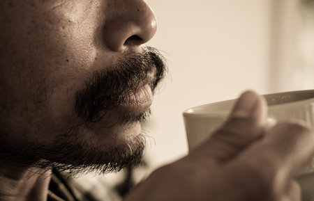 man with mustache and drinking coffeeの写真素材