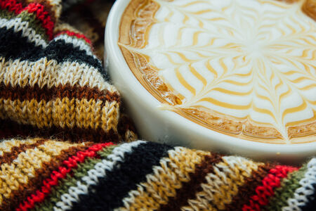 Cup of coffee surrounded the warm scarfの写真素材