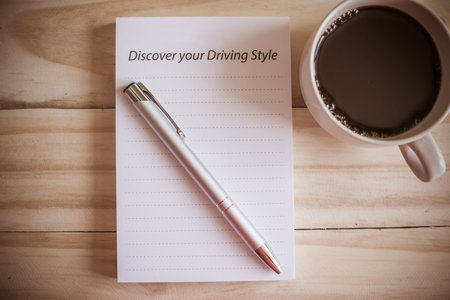 notebook pen and cup of coffee in wood table