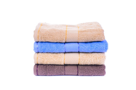 Stack of colorful towels isolated on whiteの写真素材