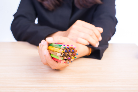 color pencils in business woman handの写真素材