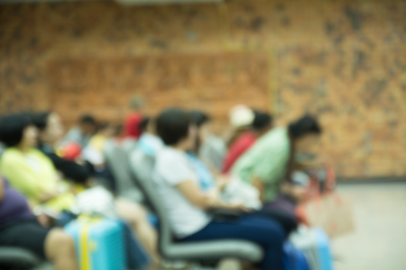 airport terminal blurred crowd of travelling people on the background.の写真素材