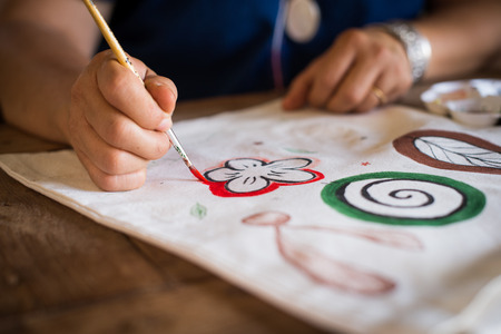 Girl use brush paint picture on bagの写真素材