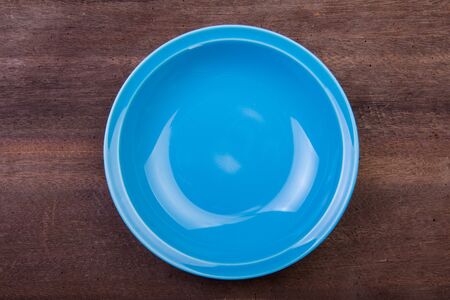 Empty plate on wooden backgroundの写真素材