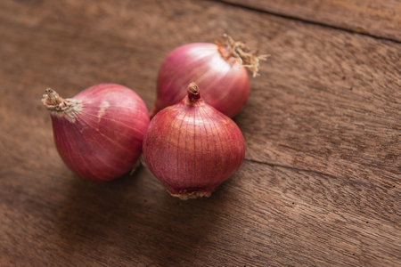 Red onion on a wooden tableの写真素材