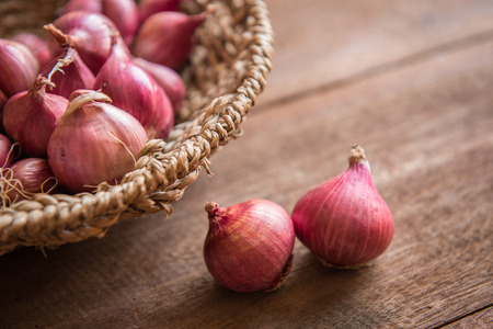 Red onion on a wooden tableの写真素材