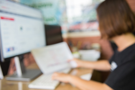 Abstract blur woman working at computer on deskの写真素材