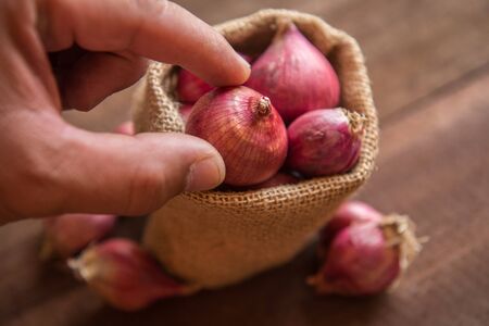 Red onion on a wooden tableの写真素材