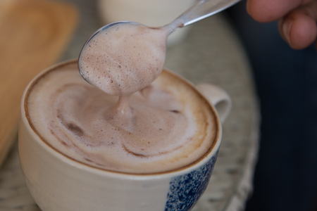 hot latte coffee on wood tableの写真素材
