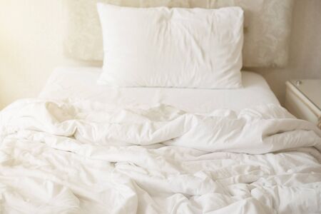 Mattresses blanket and pillows on the luxury bed in the hotel room after a restful sleep.の写真素材