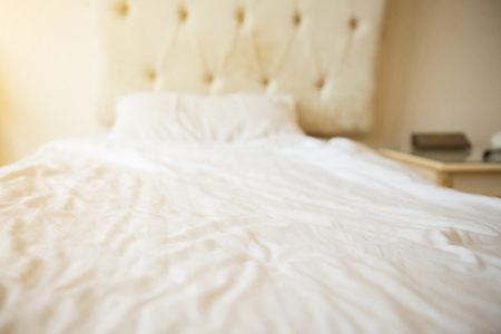 Mattresses and pillows on the luxury bed in the hotel room after a restful sleep.の写真素材