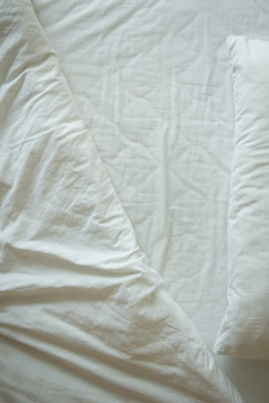 Mattresses blanket and pillows on the luxury bed in the hotel room after a restful sleep.