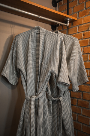 bathrobe hanging on rack in the vintage bedroomの写真素材
