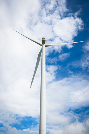 The image behind the wind turbine for electricity on a cloudy day in the blue sky.の写真素材